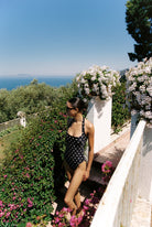 Monopoli - One-Piece in Black / White Polka Dot — garden terrace view