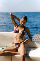 Tiramisu - Bikini in Plum and pink polka dot — seated three-quarter view