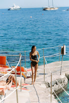 Bella - One-Piece in Black White Dot — wide seaside view