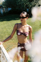 Aura - Bikini in Plum / Pink Polka Dot — full front view through flowers