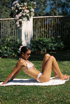 Vita - Bikini in White Cherry — reclining side view on the lawn